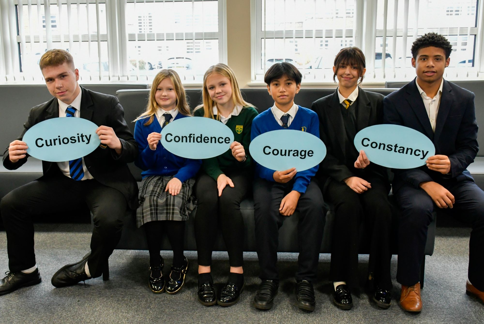 Students holding up the Four Cs words